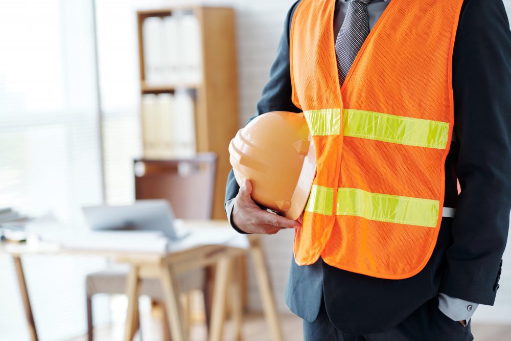 unrecognizable-male-construction-industry-executive-posing-safety-vest-with-hardhat